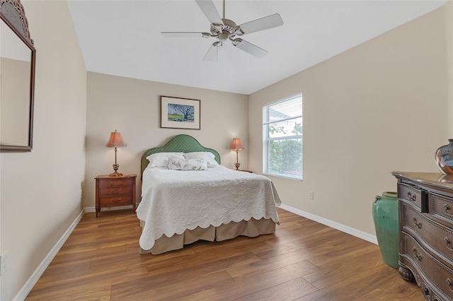 bedroom with dark hardwood / wood-style floors and ceiling fan