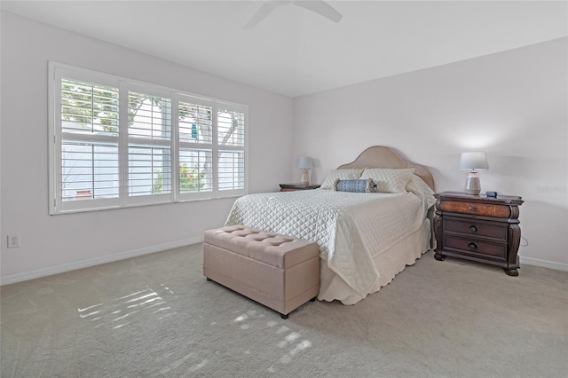 bedroom with ceiling fan and light carpet