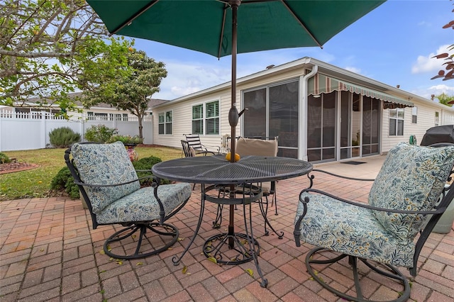 view of patio / terrace featuring a sunroom