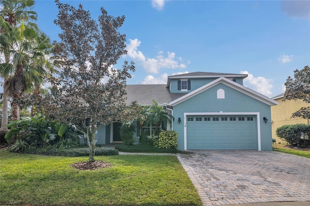 front of property with a garage and a front lawn