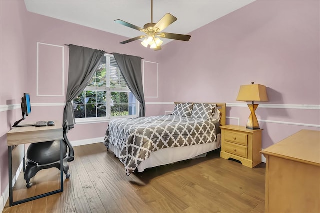 bedroom with ceiling fan and wood-type flooring