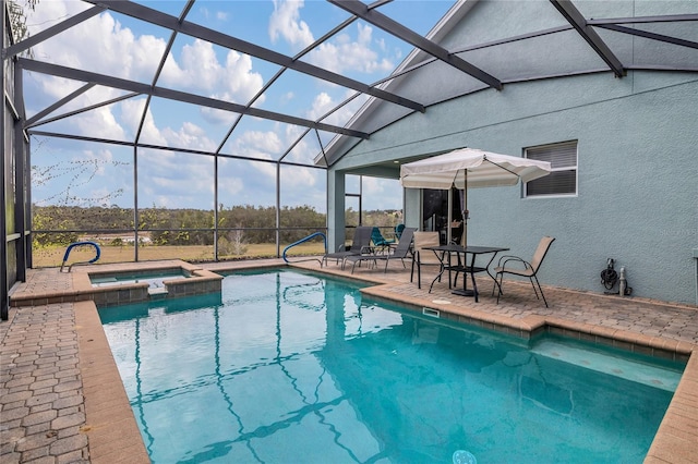 view of swimming pool featuring glass enclosure, a patio area, and an in ground hot tub