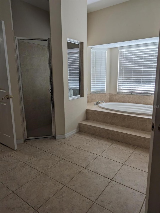 bathroom with tile patterned floors and plus walk in shower