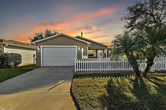 ranch-style home with a yard and a garage