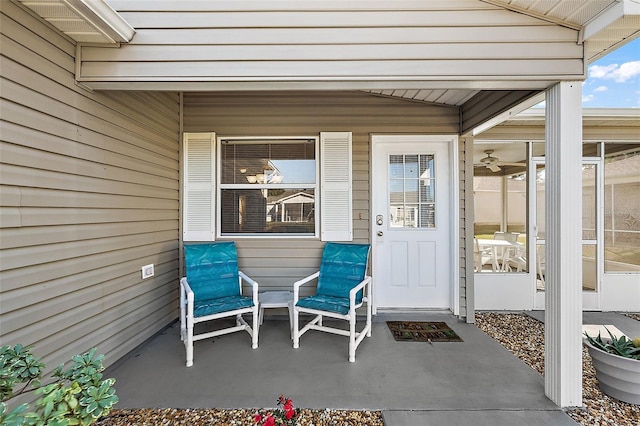 entrance to property featuring a patio area and ceiling fan