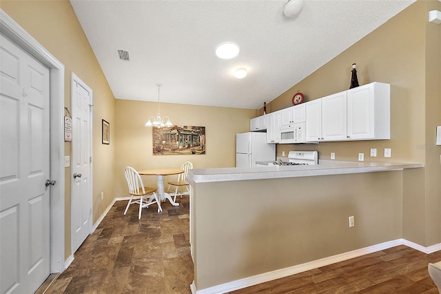 kitchen with decorative light fixtures, white cabinets, white appliances, kitchen peninsula, and a notable chandelier