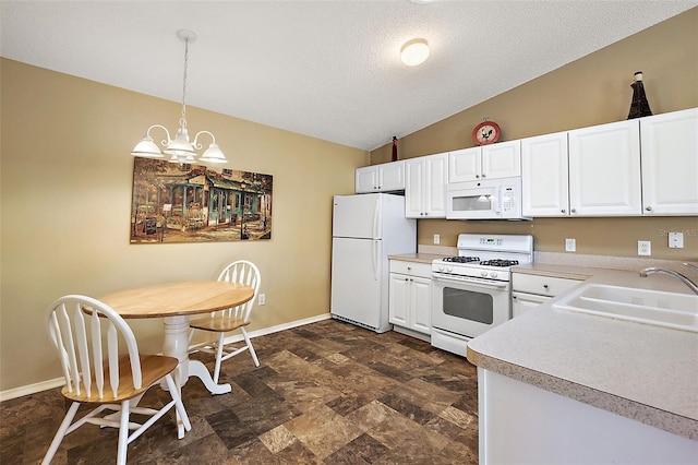 kitchen with sink, white cabinets, white appliances, pendant lighting, and a notable chandelier