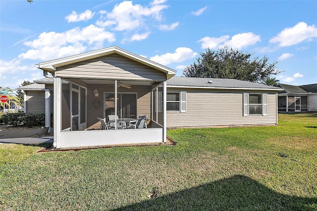 back of property with a lawn and a sunroom