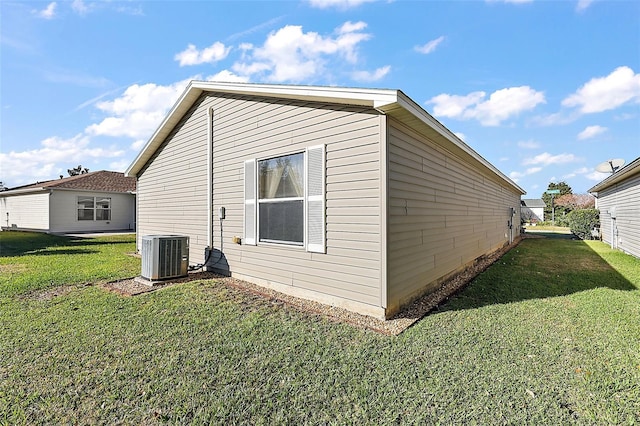 view of home's exterior featuring central air condition unit and a lawn