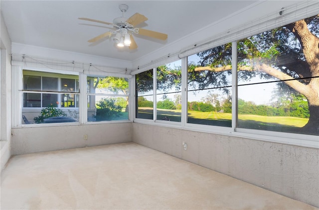 unfurnished sunroom with ceiling fan