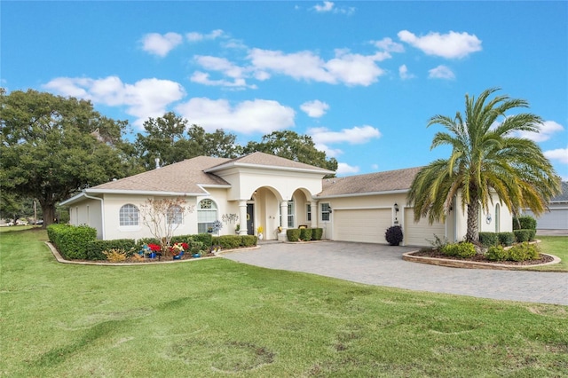 mediterranean / spanish-style home with a garage and a front yard