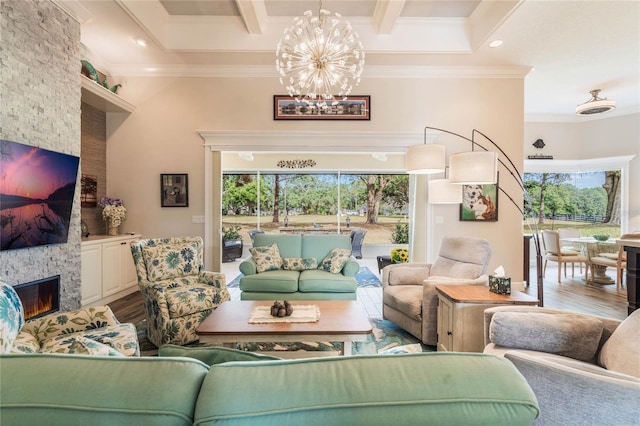 living room featuring ornamental molding, a fireplace, and a wealth of natural light