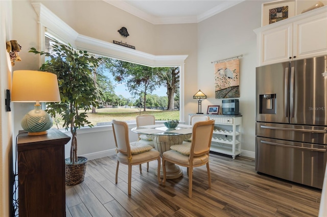 dining room with dark hardwood / wood-style flooring and ornamental molding