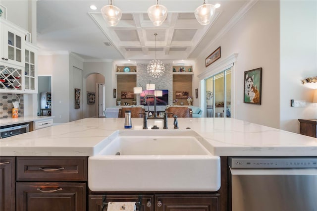 kitchen featuring beamed ceiling, dark brown cabinetry, stainless steel dishwasher, and coffered ceiling