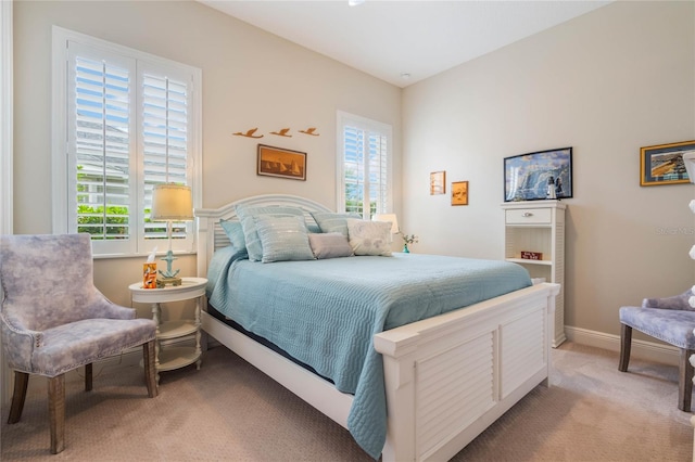 bedroom featuring light colored carpet