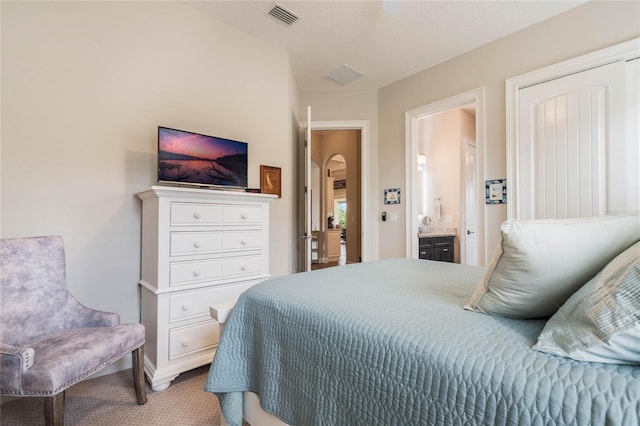 carpeted bedroom with ensuite bathroom