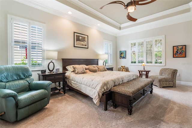 bedroom with carpet, a raised ceiling, ceiling fan, and ornamental molding