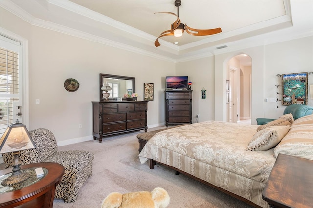 bedroom featuring light carpet, a raised ceiling, ceiling fan, and crown molding