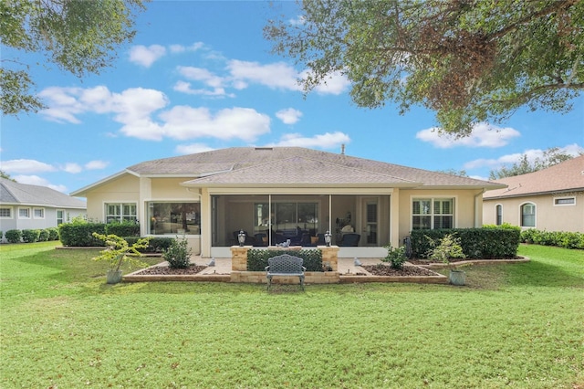 back of house with a sunroom and a yard