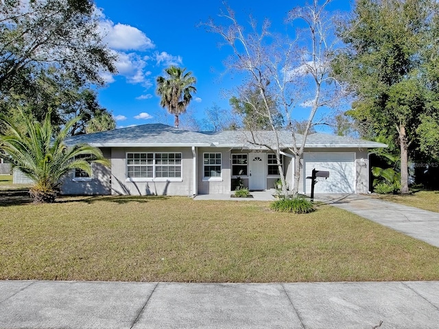 ranch-style home with a garage and a front yard