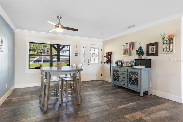 dining space featuring visible vents, ornamental molding, dark wood finished floors, and baseboards