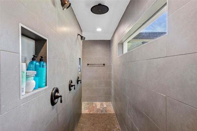 bathroom featuring tile walls and tiled shower