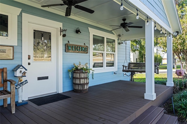 wooden terrace featuring covered porch and ceiling fan