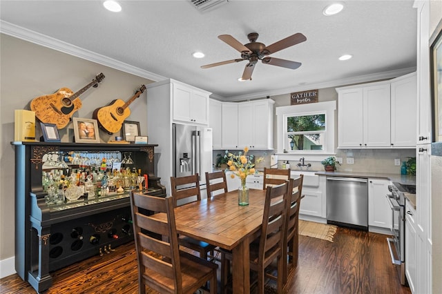 dining space with recessed lighting, visible vents, a ceiling fan, ornamental molding, and dark wood-style floors