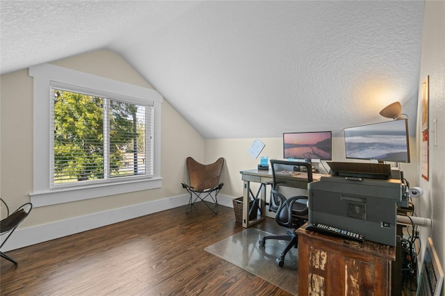 home office with a textured ceiling, baseboards, wood finished floors, and lofted ceiling