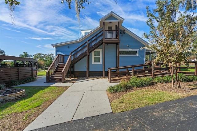 view of front of house with a deck and stairway