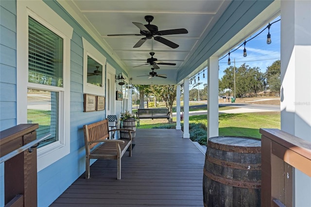 deck featuring covered porch and ceiling fan