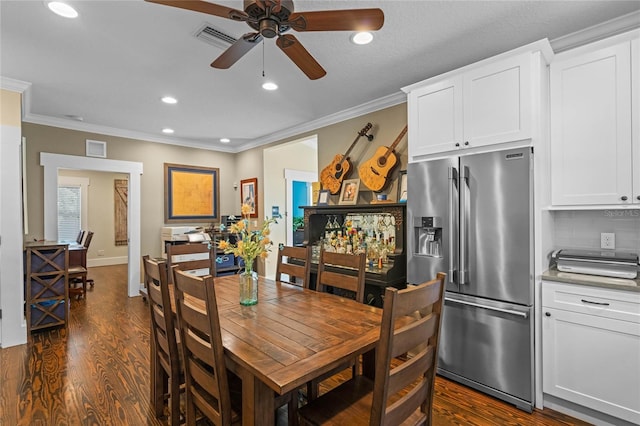 dining space with recessed lighting, dark wood-style flooring, visible vents, and crown molding