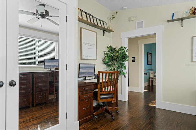 office area with a ceiling fan, dark wood-style flooring, visible vents, and baseboards