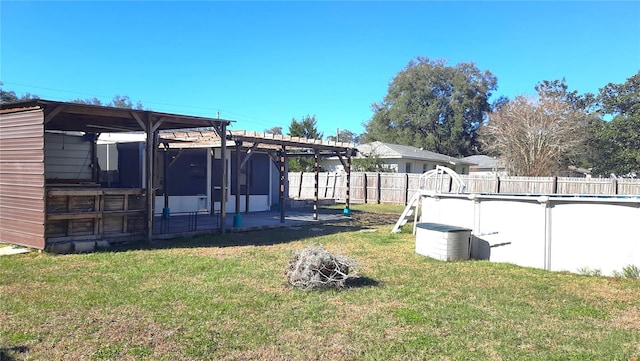 view of yard featuring a fenced in pool and a pergola