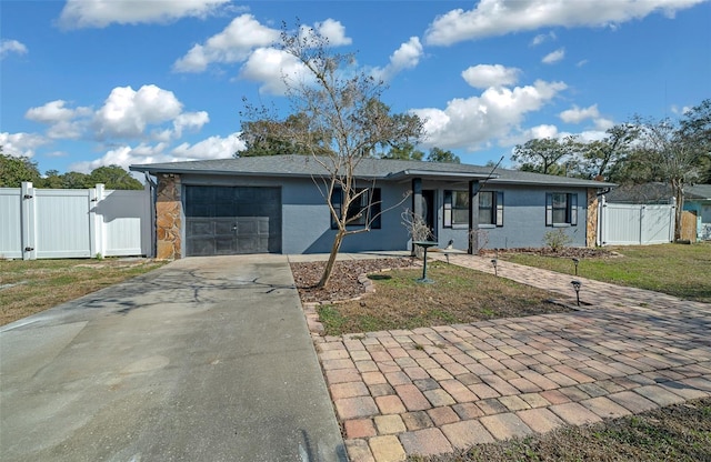 ranch-style house featuring a garage and a front lawn