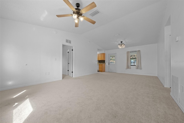 interior space with lofted ceiling, light colored carpet, and ceiling fan