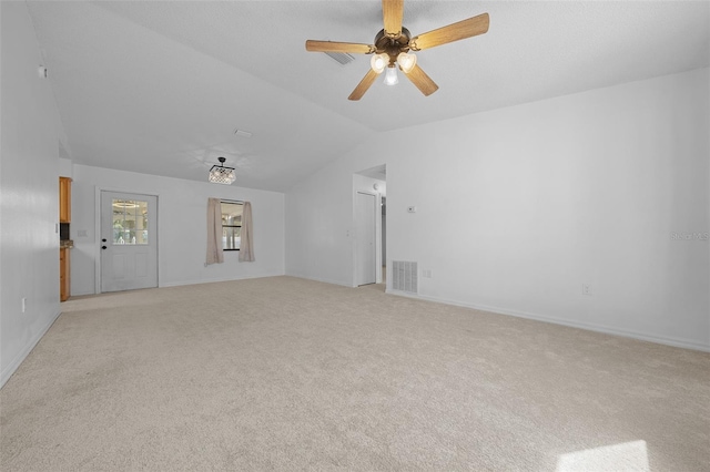 unfurnished living room with ceiling fan, lofted ceiling, and light carpet