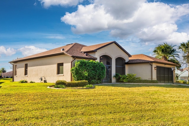 mediterranean / spanish-style house featuring a front lawn and a garage