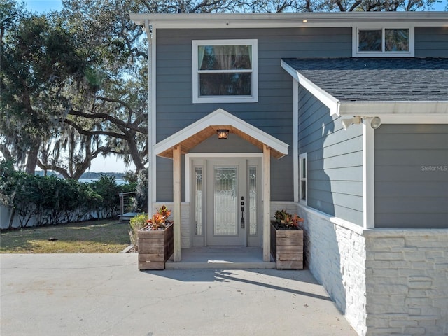 view of exterior entry with a garage