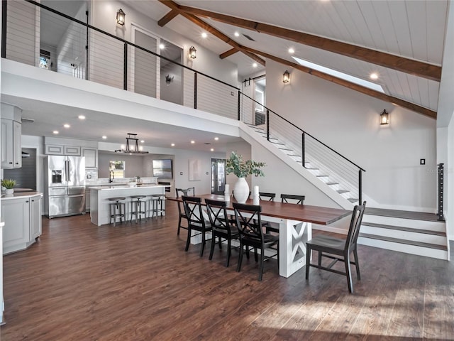 dining area with sink, dark hardwood / wood-style flooring, high vaulted ceiling, and beamed ceiling