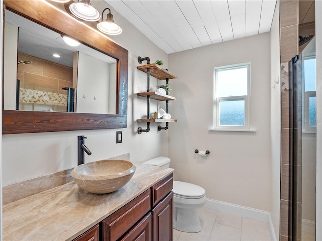 bathroom with toilet, tile patterned flooring, a shower with door, and vanity