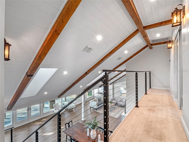 hallway with vaulted ceiling with beams