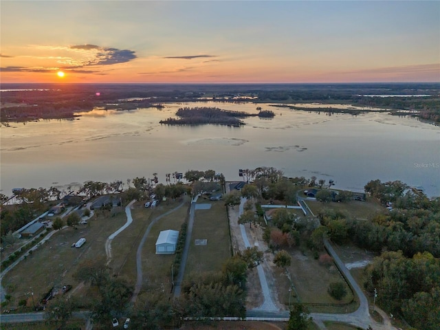 aerial view at dusk with a water view