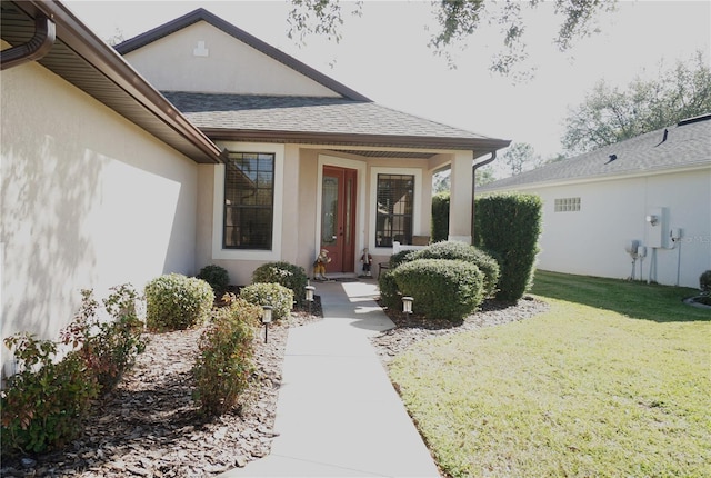 doorway to property featuring a yard and a porch