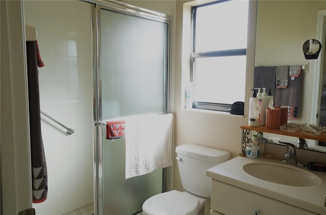 bathroom with walk in shower, vanity, and toilet