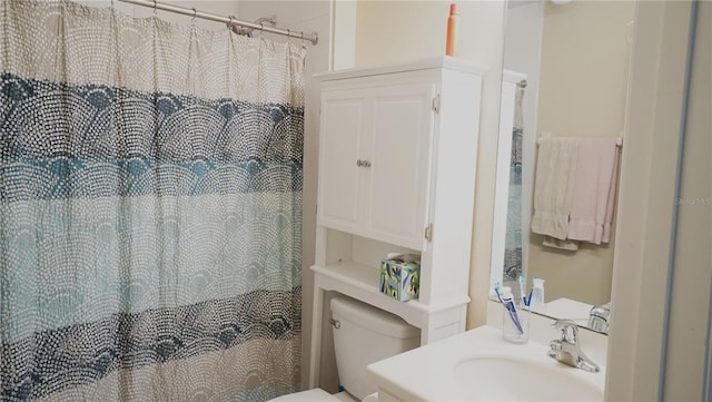 bathroom with vanity, curtained shower, and toilet