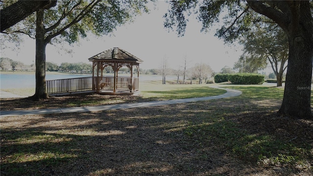 view of home's community with a gazebo, a yard, and a water view