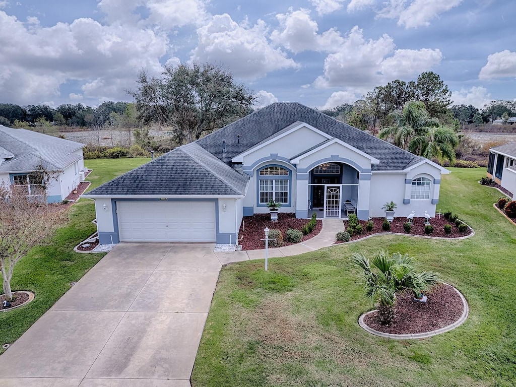 single story home featuring a garage, french doors, and a front lawn