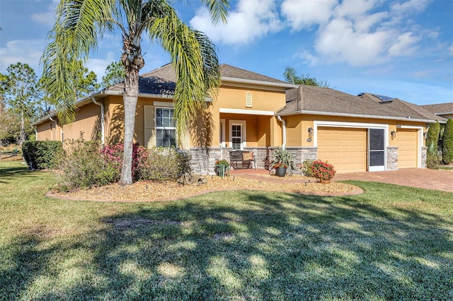 view of front of home with a front yard and a garage