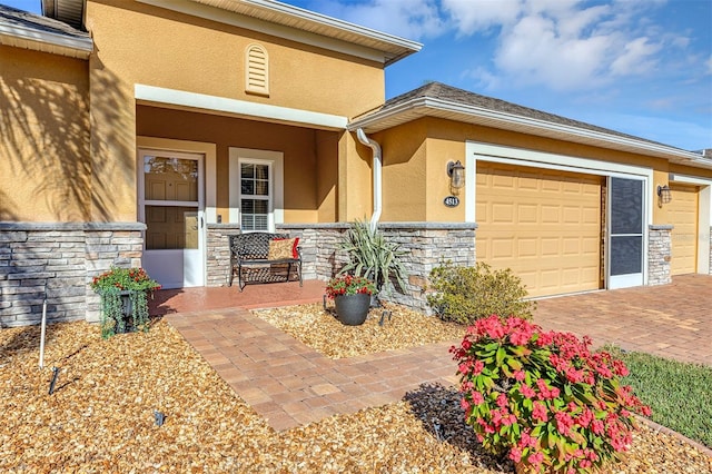 property entrance with covered porch and a garage